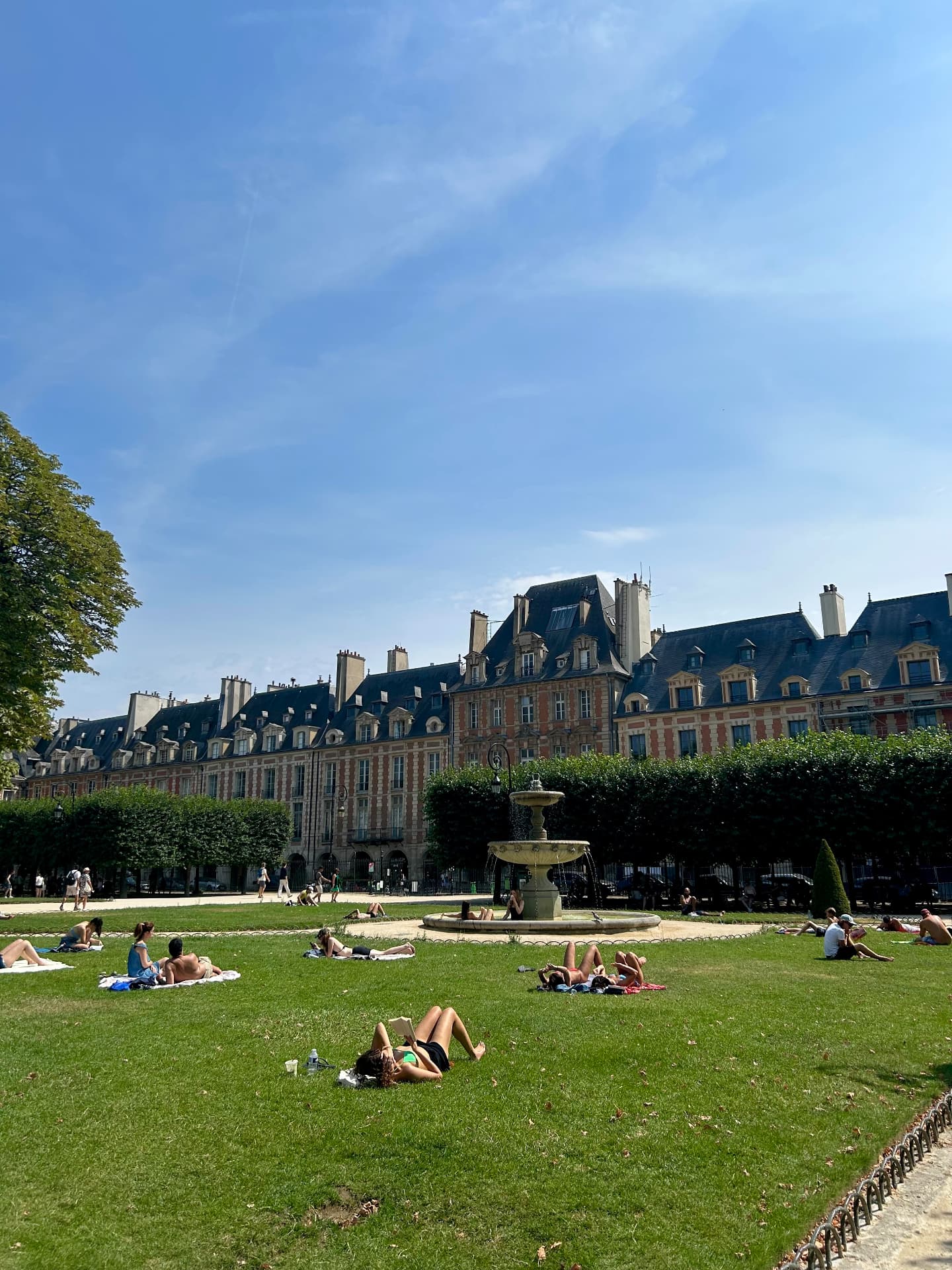 Place des Vosges and its fountain on a summer day